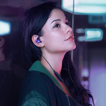 Asian lady wearing a wireless shure sound isolating earphone for her workout outdoors